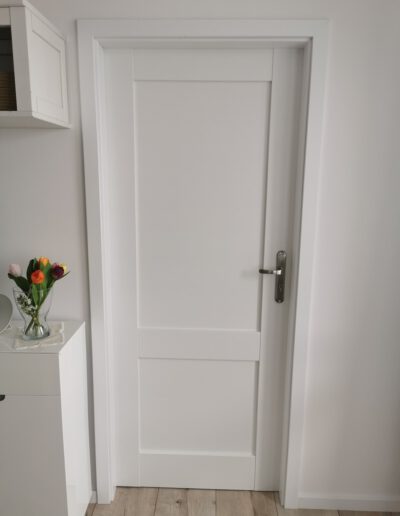 Białe minimalistyczne drzwi do pokoju